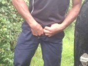 Hauls out cock and balls, pisses on the ground, in rubber boots and uniform