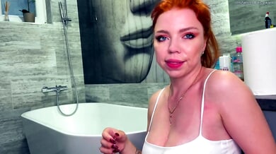 Redhead swallows deep in sleek bathroom scene