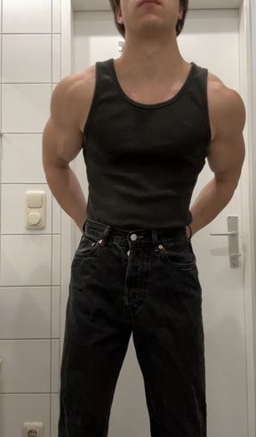 Young college guy flexing his muscles