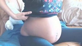 Chocolate skin preggo babe undresses and pleases herself