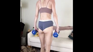 Skinny blonde babe flexes fit legs in gym workout