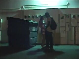 Sexually excited cougar sucks a large ebony shlong in the alley