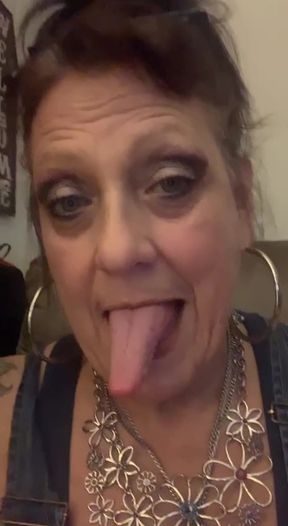 Long tongues intertwine in a saliva-filled fetish scene.