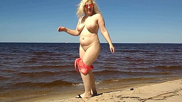 Blonde flashing pussy on the beach