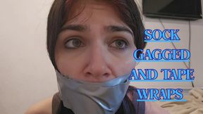 Sock gagged and silver tape wraps tight moaning
