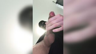 Beautiful dude in a mask is stroking and cuming on socks