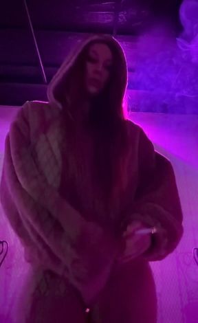 Smoking a Cigarette Outdoor While Wearing Only a Bikini and a Jacket