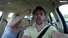 First hands on the steering wheel then mouth on the cock