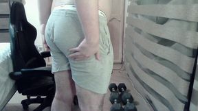 Muscular camboy flexes his muscles and squats