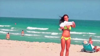 Sexy curves are seen on the beach in this scene