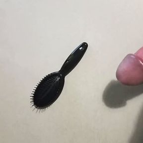 Jerking off on a small hairbrush, cumshot with a lot of cum from a big cock by an handjob.