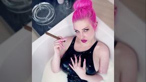 Smoking cigar in milk bath wearing PVC swimsuit