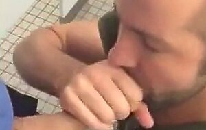 Handsome guy sucks dick in restroom stall