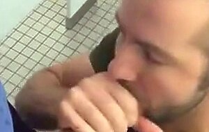 Handsome guy sucks dick in restroom stall