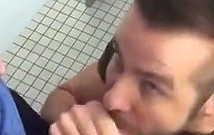Handsome guy sucks dick in restroom stall