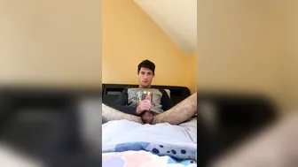 Slim twink Liam Carter jerks his big cock on the couch