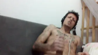 Muscular tattooed Brazilian guy strokes his big cock to a cumshot