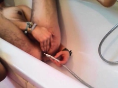 Bi-guy using shower head, squirting water, enema