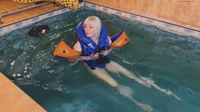 Alla wears a rare Snorke Pro inflatable vest and inflatable armbands while swimming in the pool