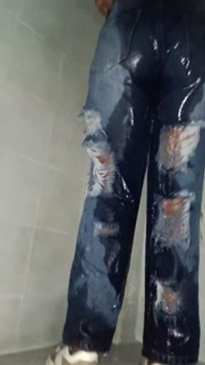 Wet girlfriend in the shower with jeans and sneakers