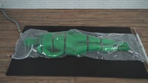 Green nylon zentai suit in a plastic vacuum bag bondage harness