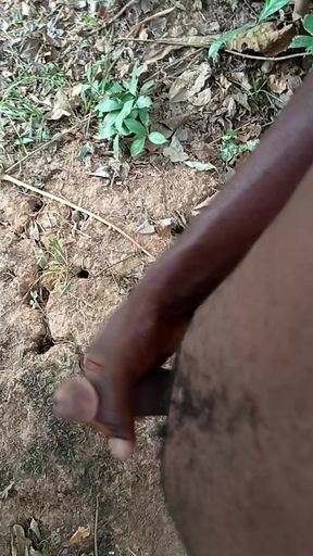 A boy masturbating with his big dick inside the bush