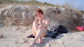 A biker girl strips naked and masturbates on a wild beach.