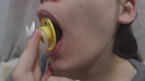 My Indian Stepsister Sucking Pacifier her sucker licks the pacifier because she loves it so much she doesn't give it to anyone because it's only hers