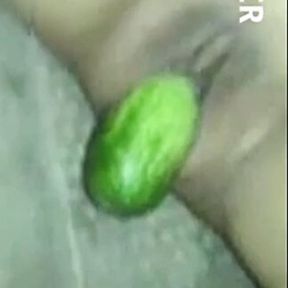 Malay girls play with cucumber