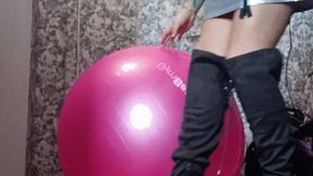nun in boots jumping on gym pink ball