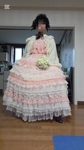 A man dressed as a woman dances in a dress.