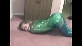 Fetish chick loves being wrapped in green plastic with her shaved pussy