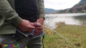 Pissing outdoor by a mountain lake, then I jerk off my shaved, foreskin cock.