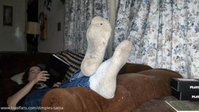 I chill on the living room couch with my feet propped up