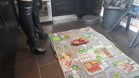 MissaRaeBerry toy car crush 1970s Chevrolet pickup in black knee high high heeled boots high left view