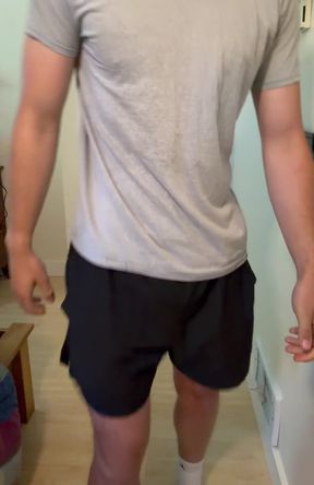 Man in grey shirt and black shorts