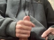 A guy in a gray sweater on a chair cums with a waterfall