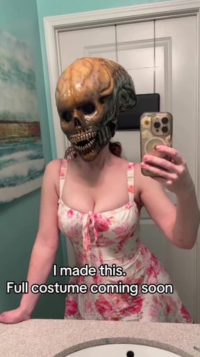 Busty cosplay girl shows off her cleavage in a mask