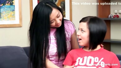 Two Asian lesbians explore each other with fingers and anal toys on the couch