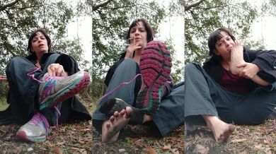 Takes off shoes and socks playfully and rubs sweaty feet in ash pit, spits and licks