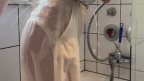 White longsleve, with beige pants in shower and bathtub