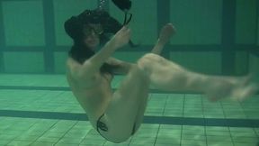 Slender pale skin babe from Russia topless in the pool
