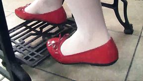 Pretty brunette chick Petra wears red flats while working with sewing machine