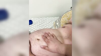 Fat guy is rubbed with oil while playing with his dick