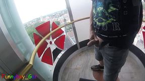 I jerk my cock very riskily in a transparent outdoor elevator on the 13th floor. I cum on the ride down.
