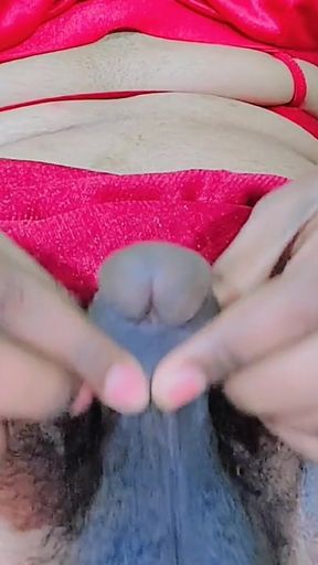 Shemale Rubbing Her Flaccid Penis and Trying Hard to Get It Erect