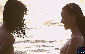 Lesbian Asian and European girlfriends playing in the ocean