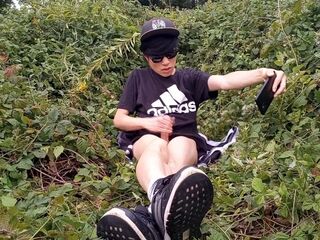 Cute French-Oriental homosexual twink jerks off his bald knob outside cums thick cum sticking to his fingers