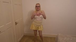Dancing striptease in yellow miniskirt and pantyhose