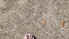 Tempest walking in grey flip flops and calves